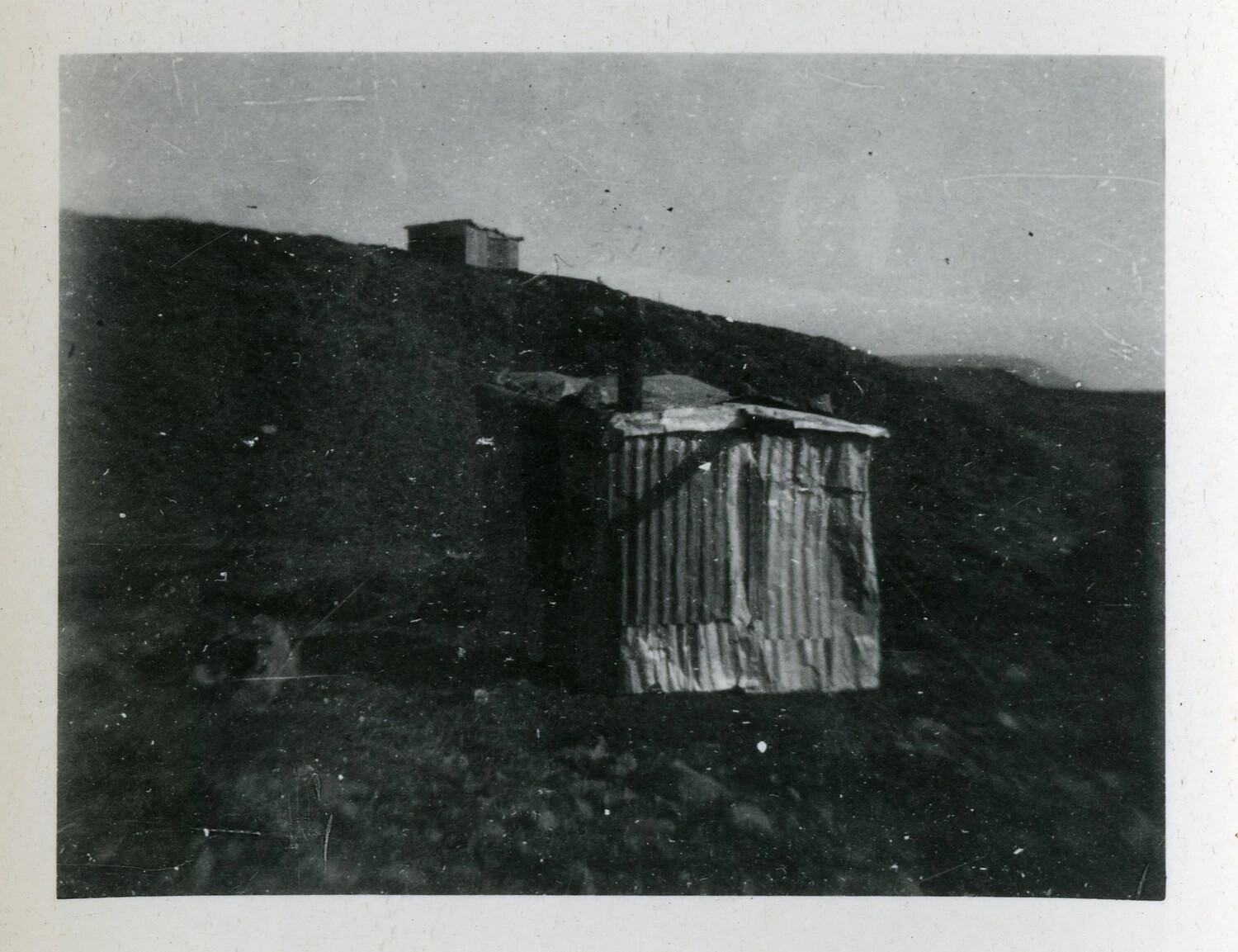 Corrugated Metal Shack on Barren Hillside, Likely Aleutian Islands, World War II