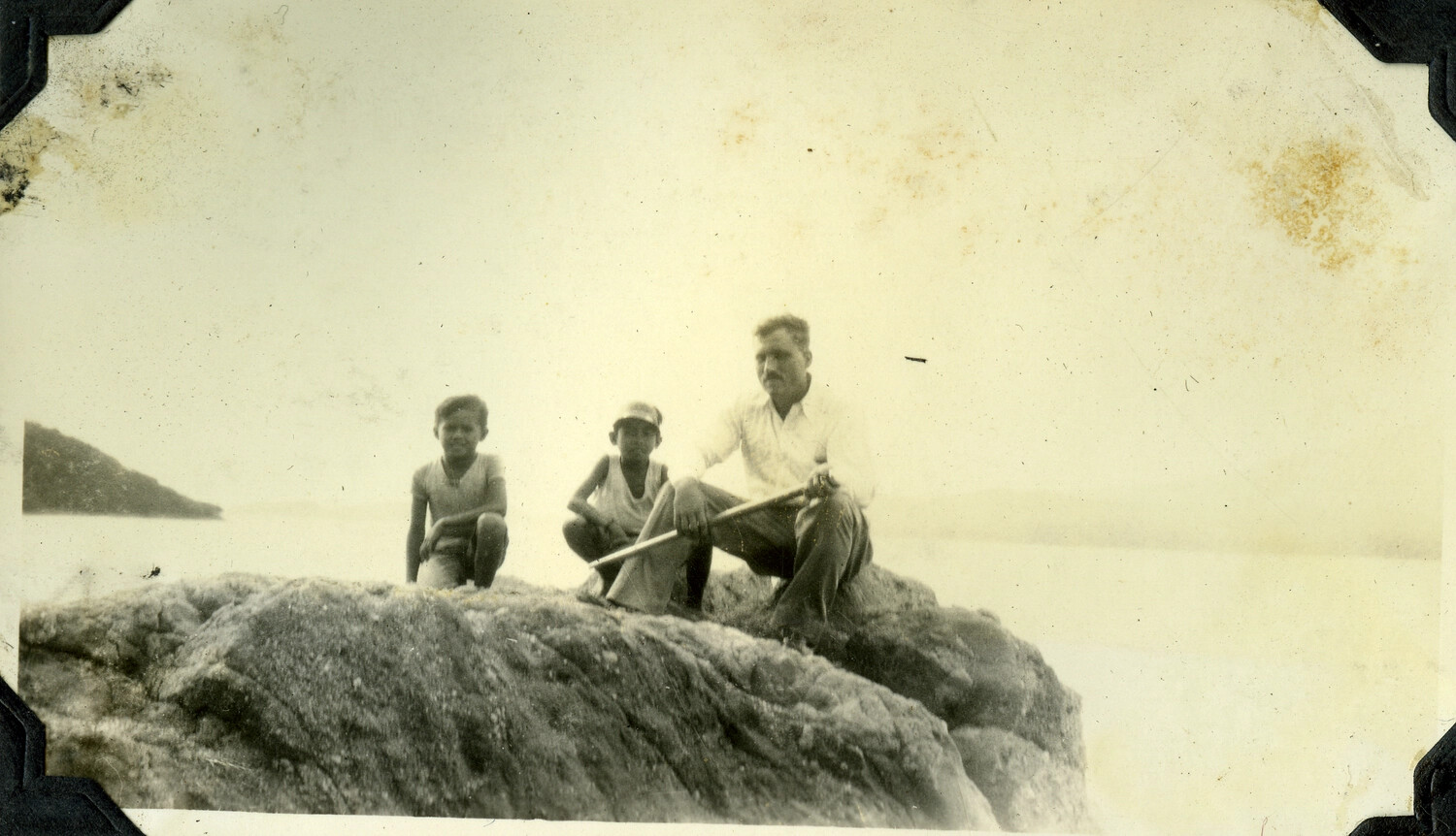 Man and Two Boys on Shoreline Rock, Philippines Photo Album