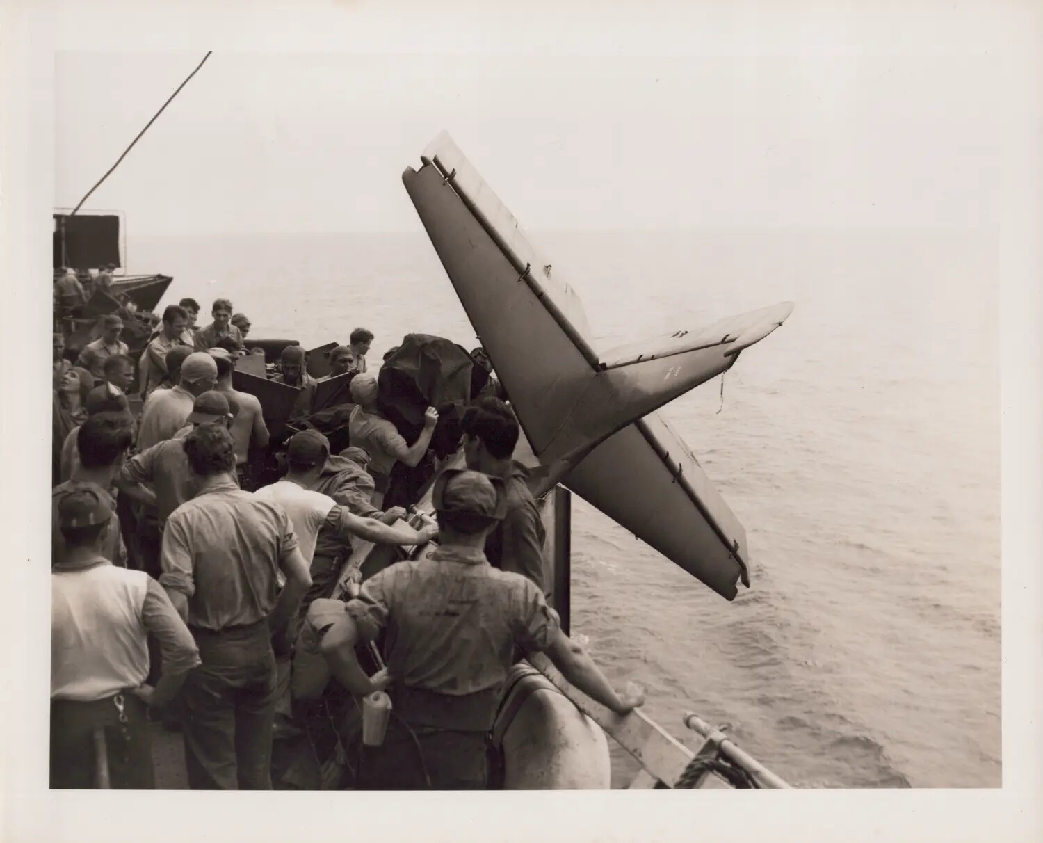 Sailors Gather Around Wrecked FM-2 Wildcat Tail Lodged in 20mm Gun Sponson, Likely U.S.S. Petrof Bay (CVE-80), December 1944