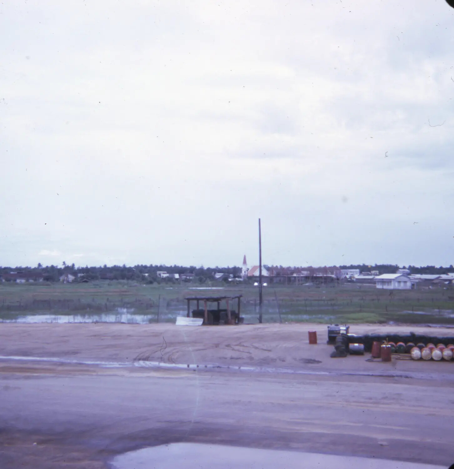 Perimeter View of US Installation with Vietnamese Town and Church Steeple, Vietnam War Era