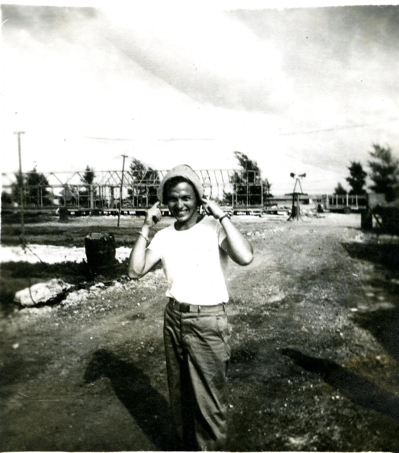Serviceman Clowning for the Camera Amid Camp Construction