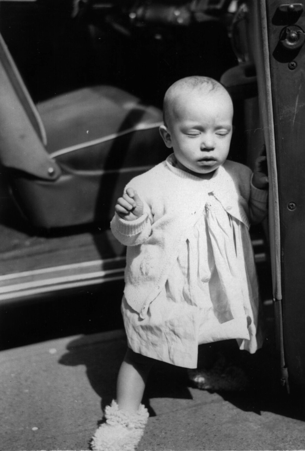 Family Snapshot of a Toddler Beside a Vintage Automobile
