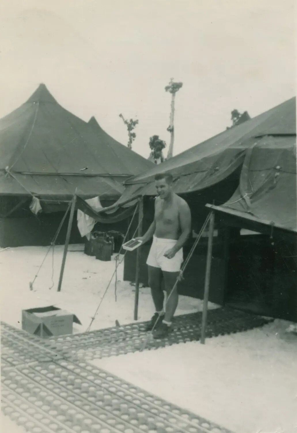 Serviceman at Tent Encampment on Marston Matting, Pacific Theater, WWII