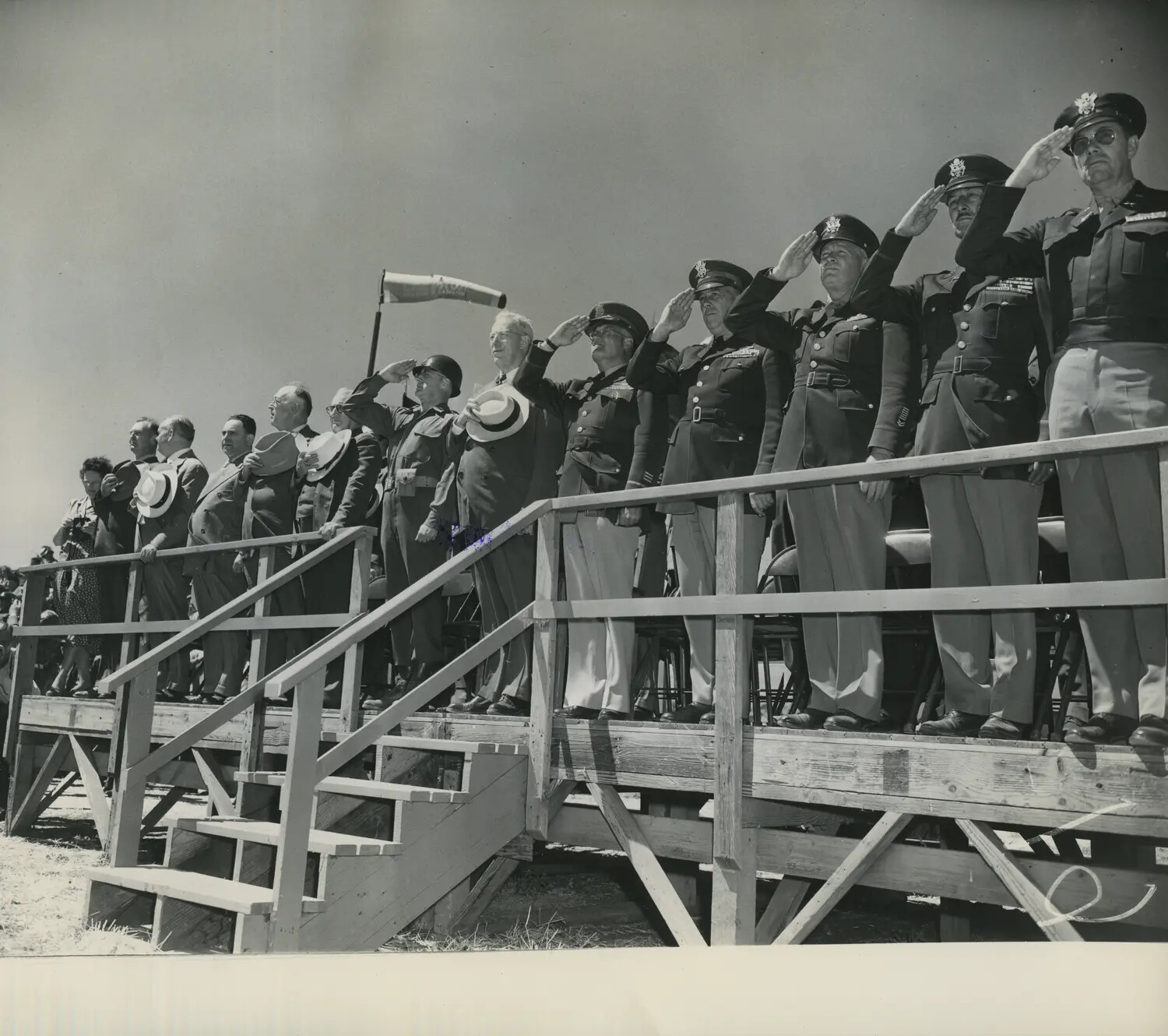 Officers and Dignitaries Saluting at Military Airfield Review Stand