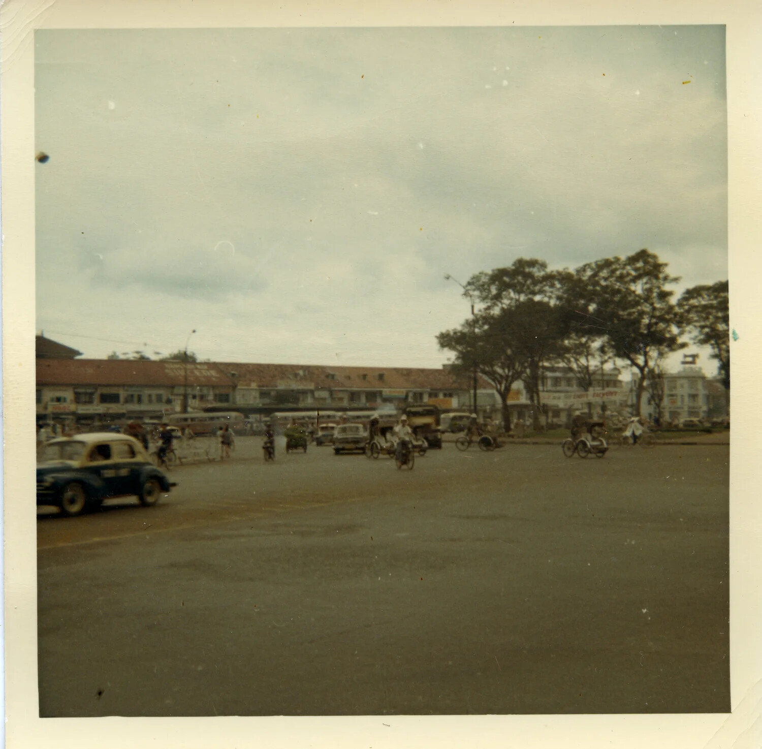 Street Scene with Taxi, Cyclos, and Shophouses, Saigon, South Vietnam, 1964