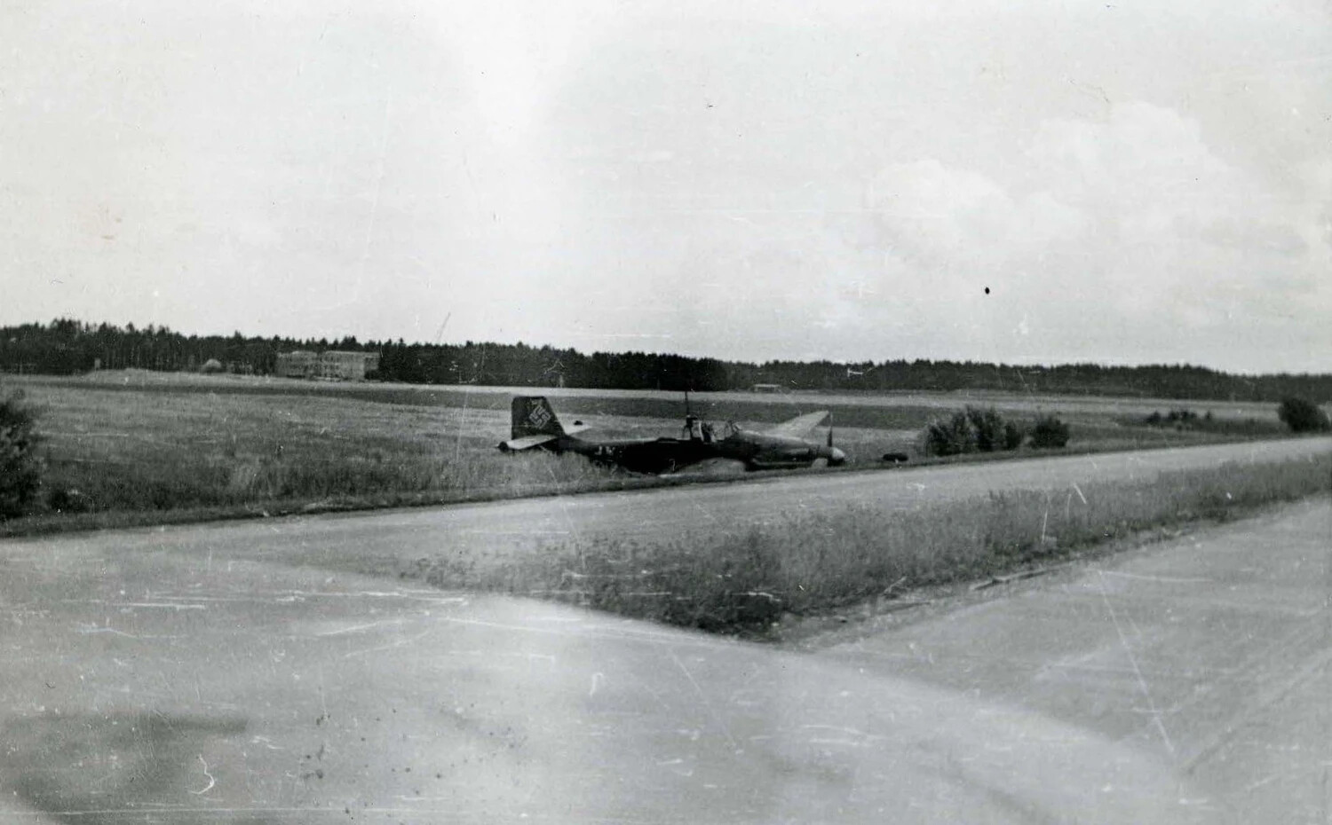 Abandoned German Luftwaffe Aircraft in Field Beside Roadway, European Theater, WWII