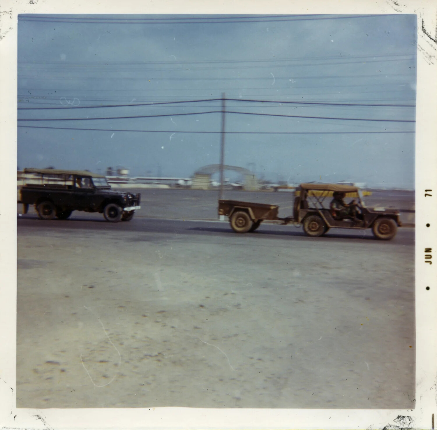 Military and Utility Vehicles on Base Access Road, South Vietnam, June 1971