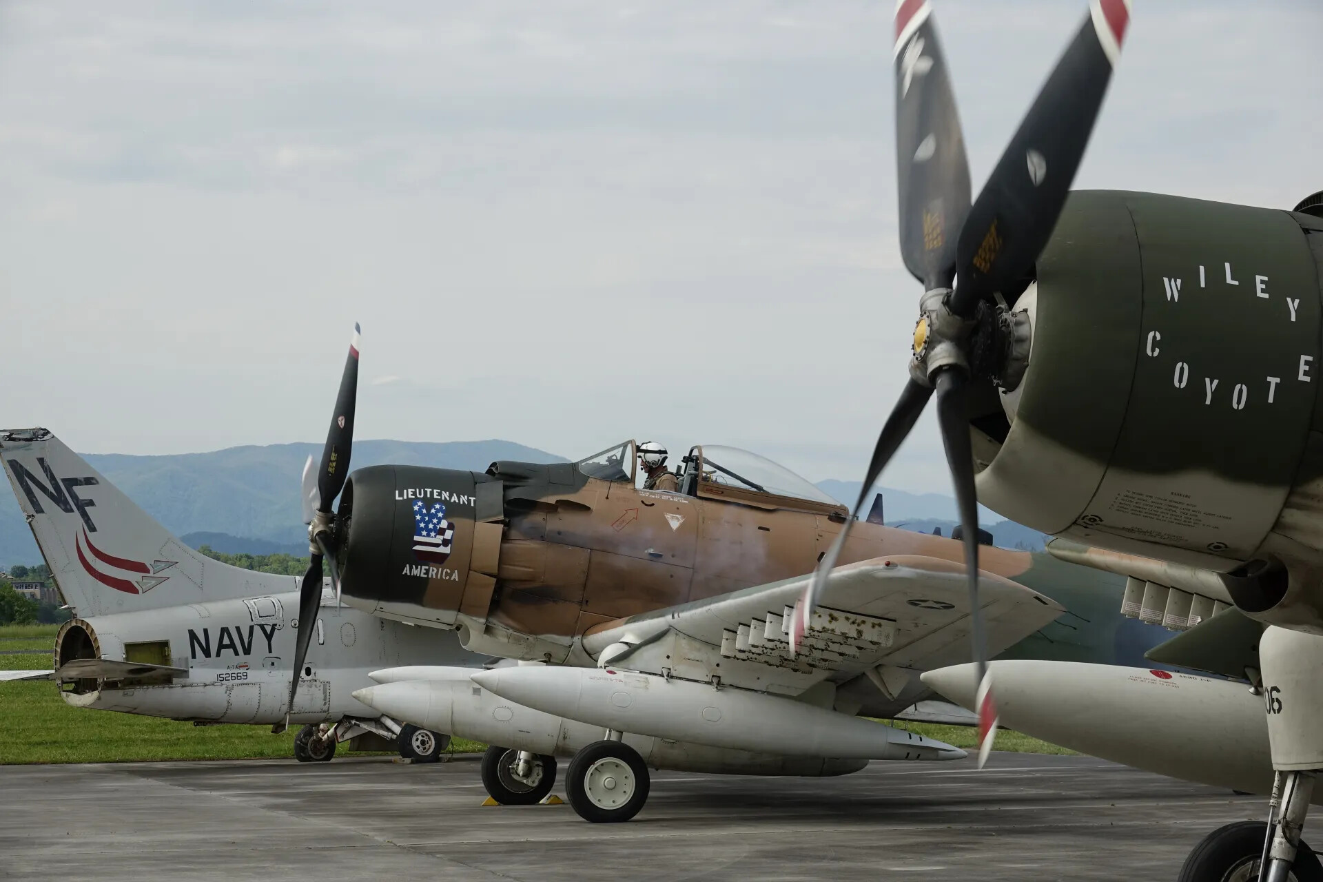 Warbird Ramp Scene: A-1 Skyraiders "Lieutenant America" and "Wiley Coyote" with A-4 Skyhawk "NAVY 152669"