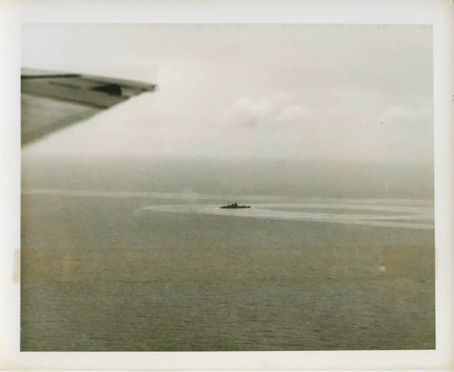 Aerial View of Escort Vessel Executing Turn, Photographed from Carrier Aircraft, USS Petrof Bay (CVE-80) Task Group, WWII Pacific