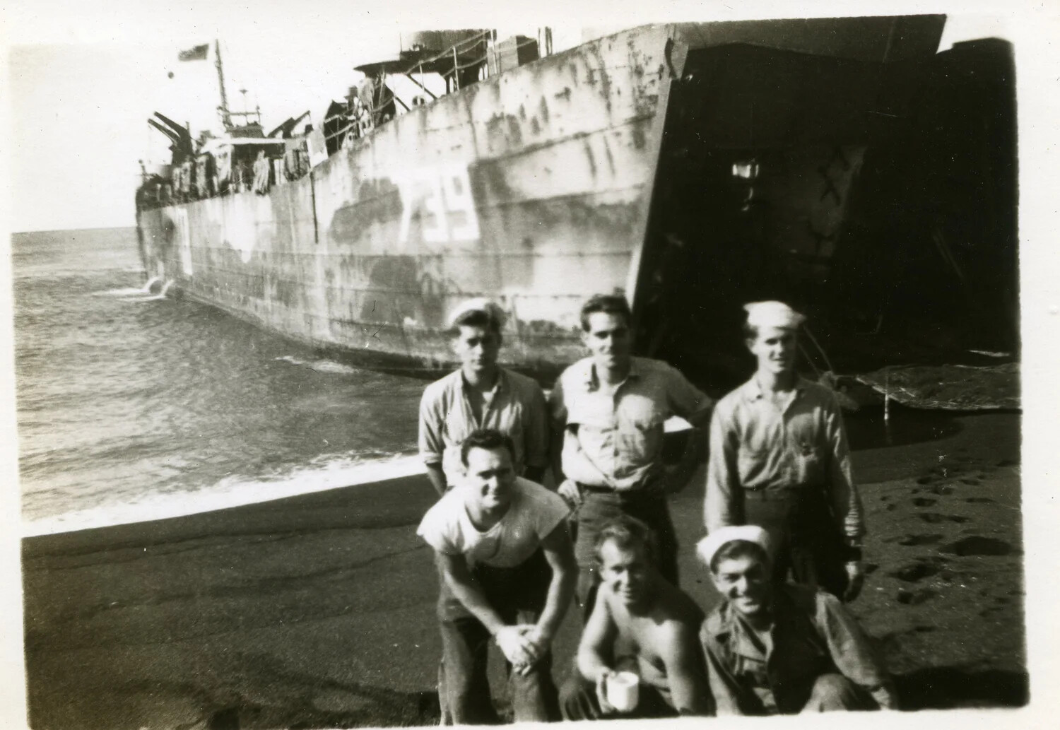 Sailors Posing on a Beach Before a Grounded Landing Ship