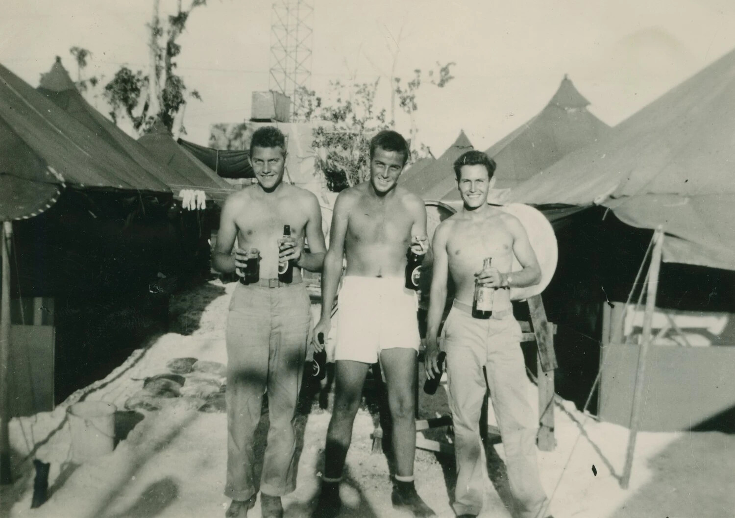 Three Shirtless Servicemen with Beer Bottles at Tent Camp, Pat McAleer Photo Album