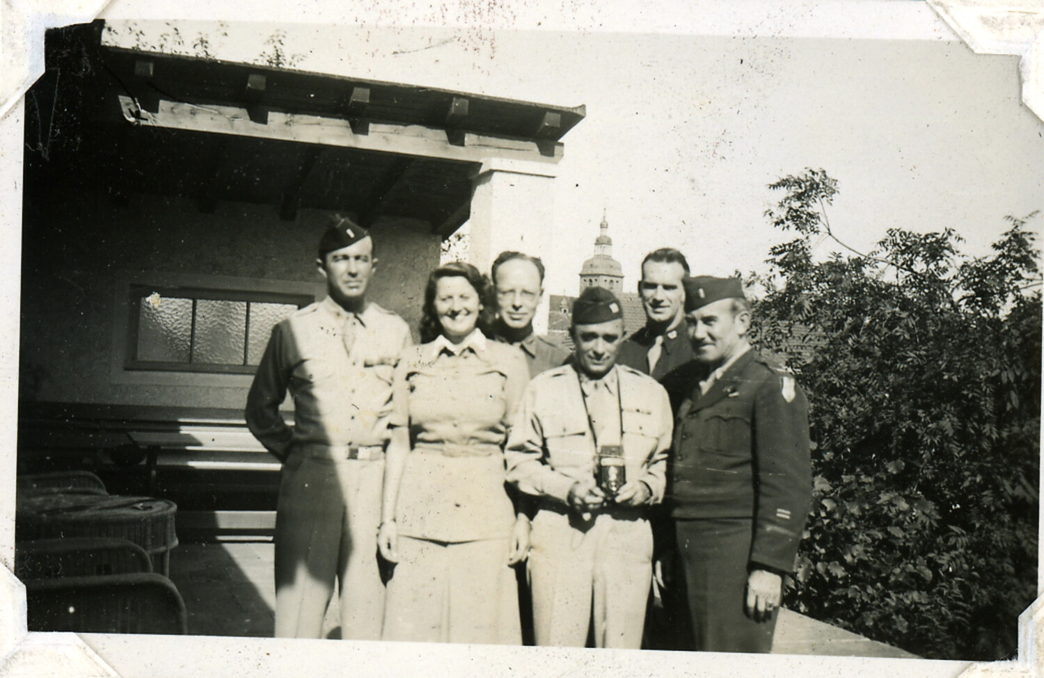 Group Portrait of U.S. Military Personnel and Civilian Woman on a Terrace, European Setting, WWII Era