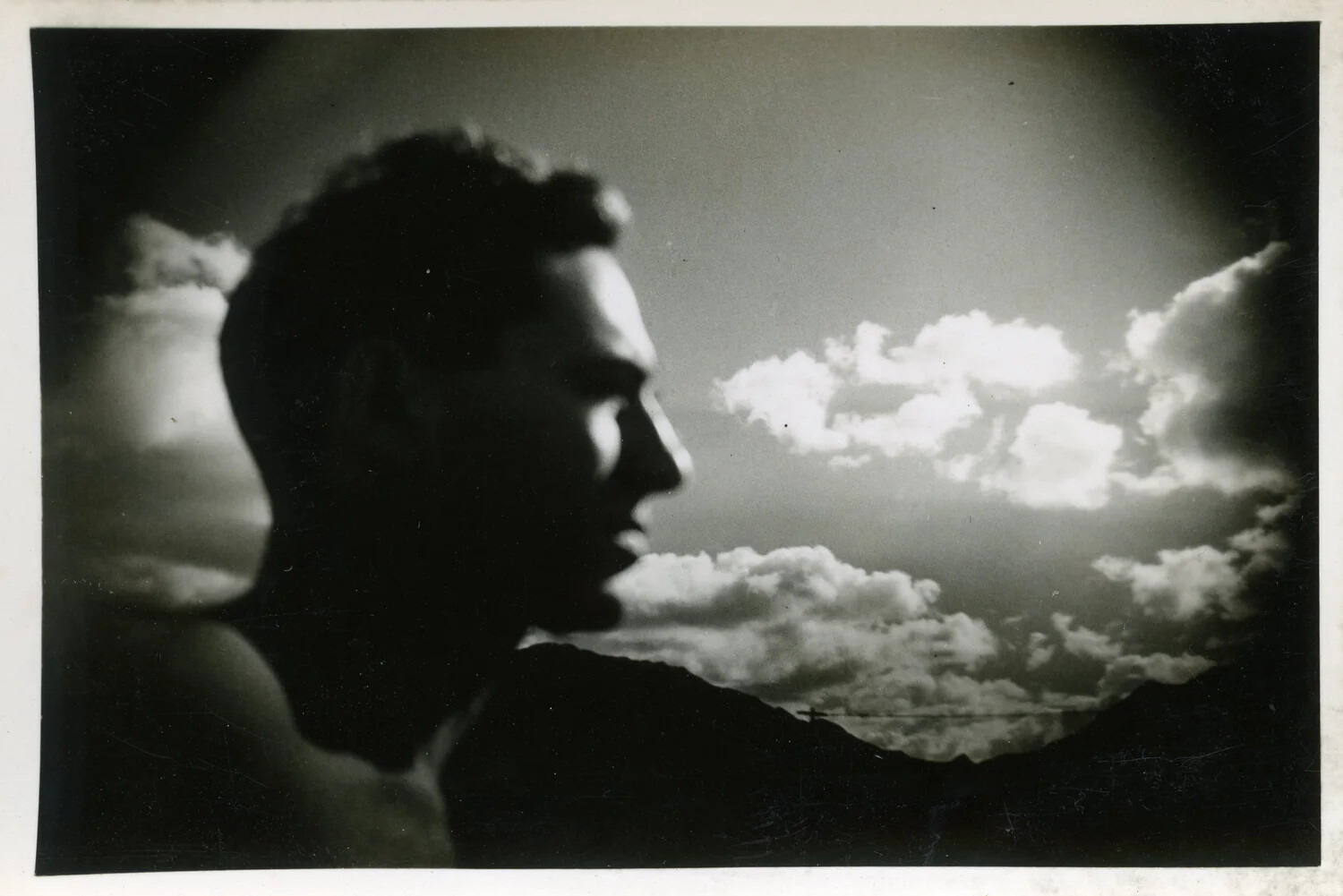 Silhouetted Portrait of a Young Man Against a Cloud-Filled Sky