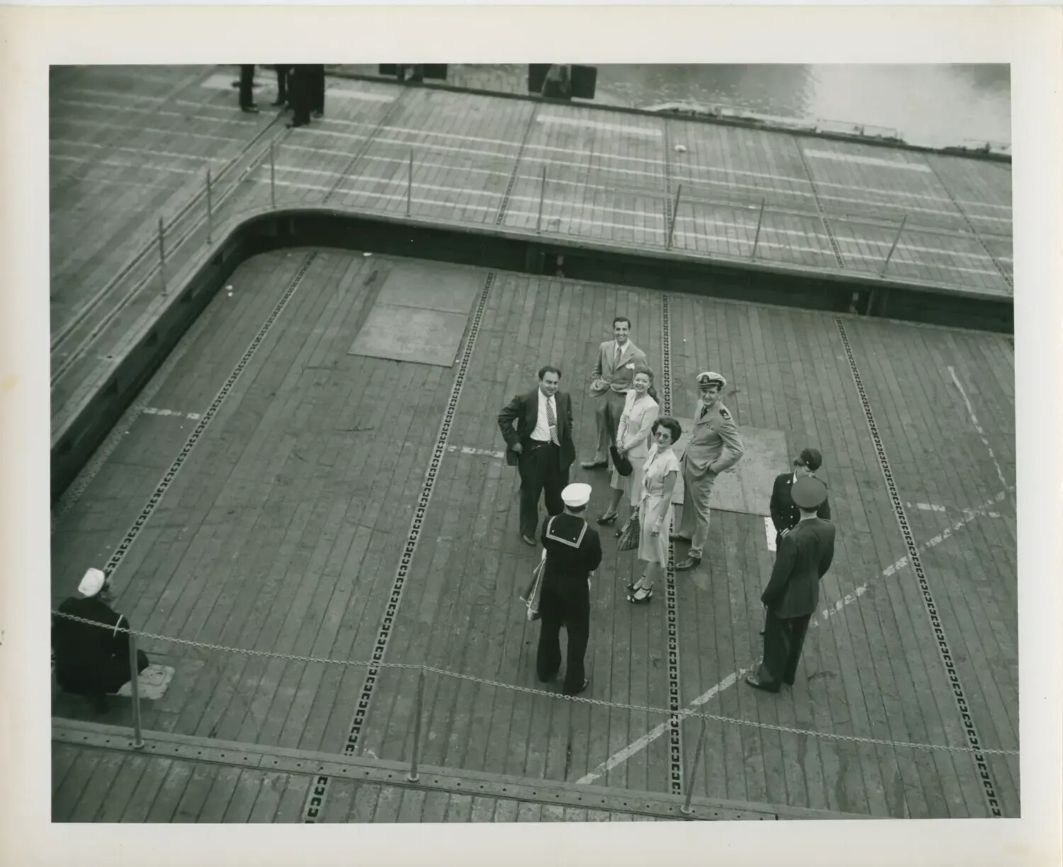 Civilian Visitors and Officer on Flight Deck, USS Petrof Bay (CVE-80), WWII Era