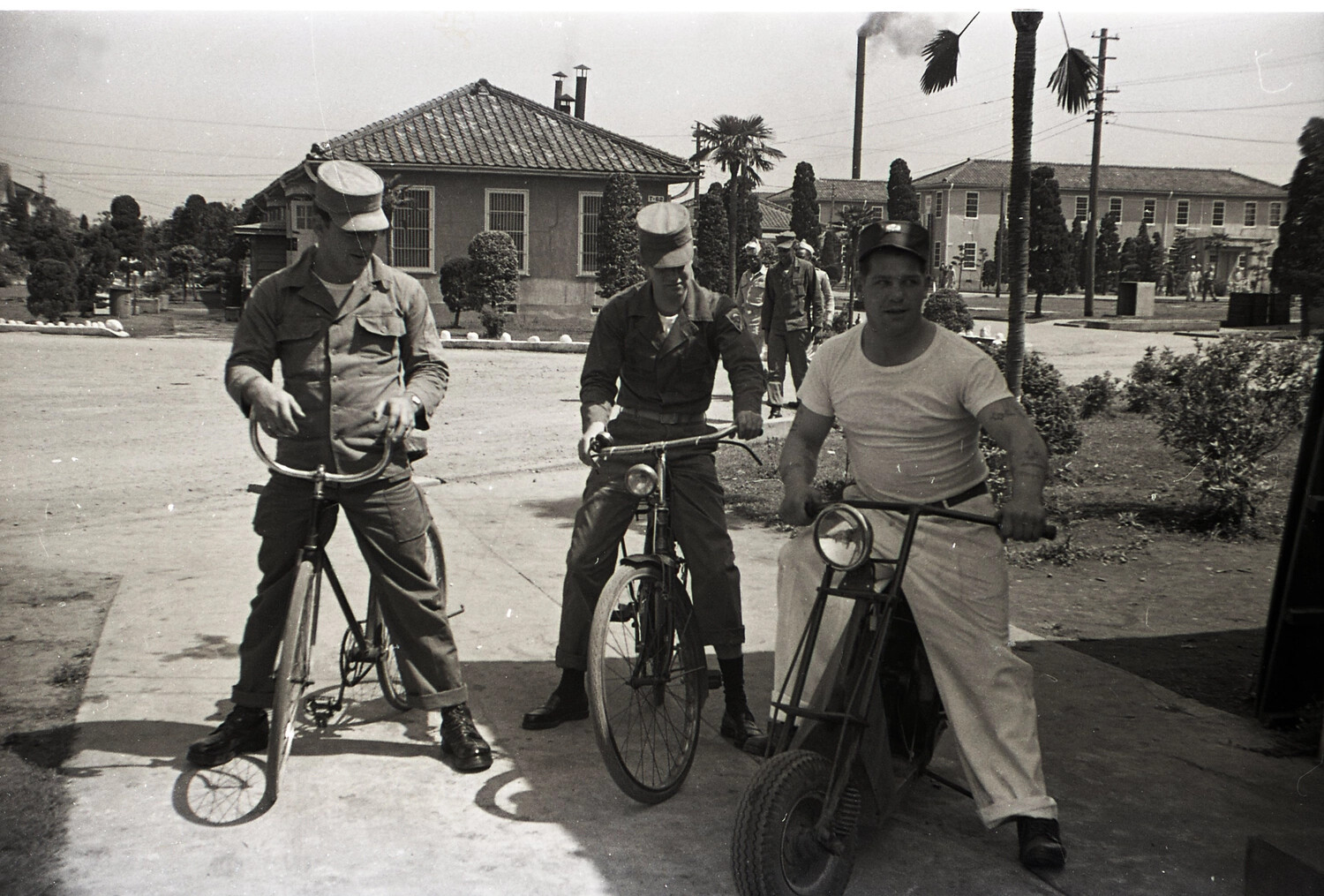 U.S. Army Soldiers on Bicycles and Motorbike at a Garrison Compound, Japan, Korean War Era (187th Airborne Association), Early 1950s