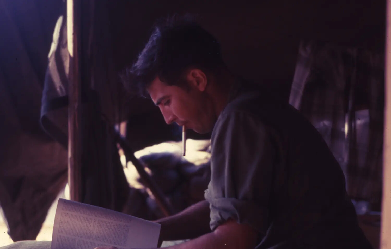 Vietnam War Era Color Slide: Serviceman Reading by Lamplight Inside Tent Quarters, Vietnam