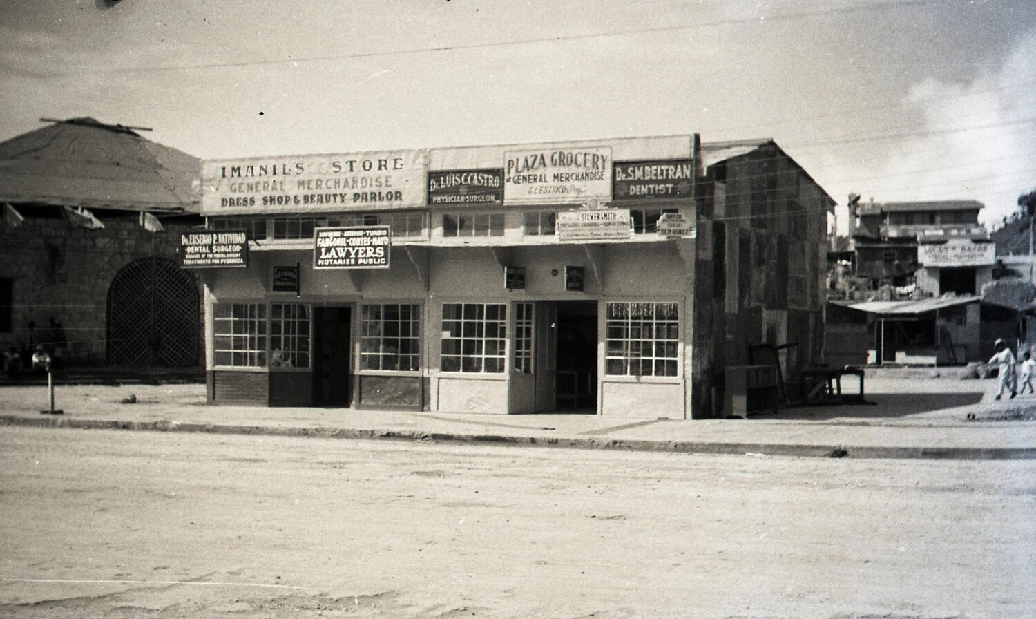 Commercial Storefront Row with Multiple Business Signs, Likely Baguio, Luzon, Philippines, WWII Era