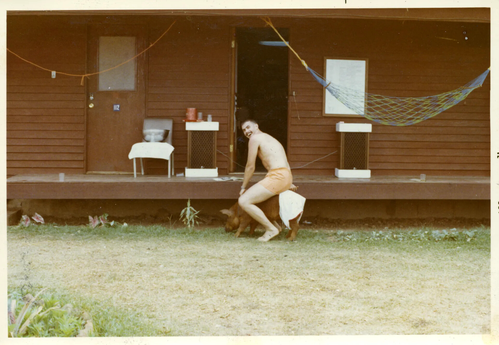 Airman with Pet Pig Outside Barracks Building 112, NKP Air Base
