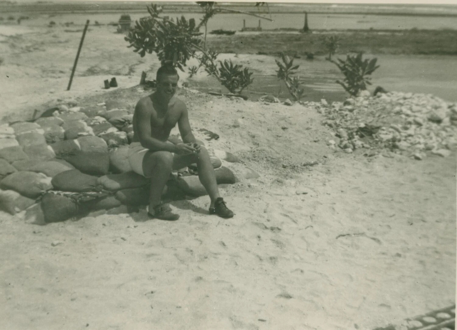 Serviceman Resting on Sandbagged Emplacement, Pacific Island Beach, WWII