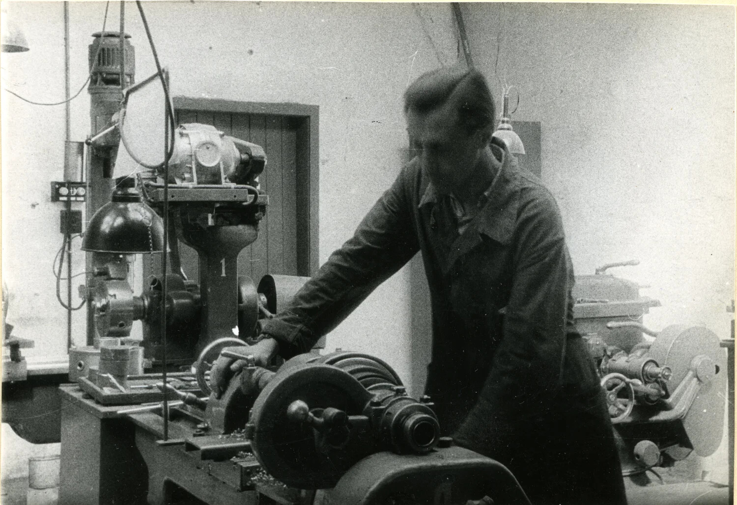 Close-Up Detail: Machinist Operating a Turning Lathe in a Germany Depot Workshop