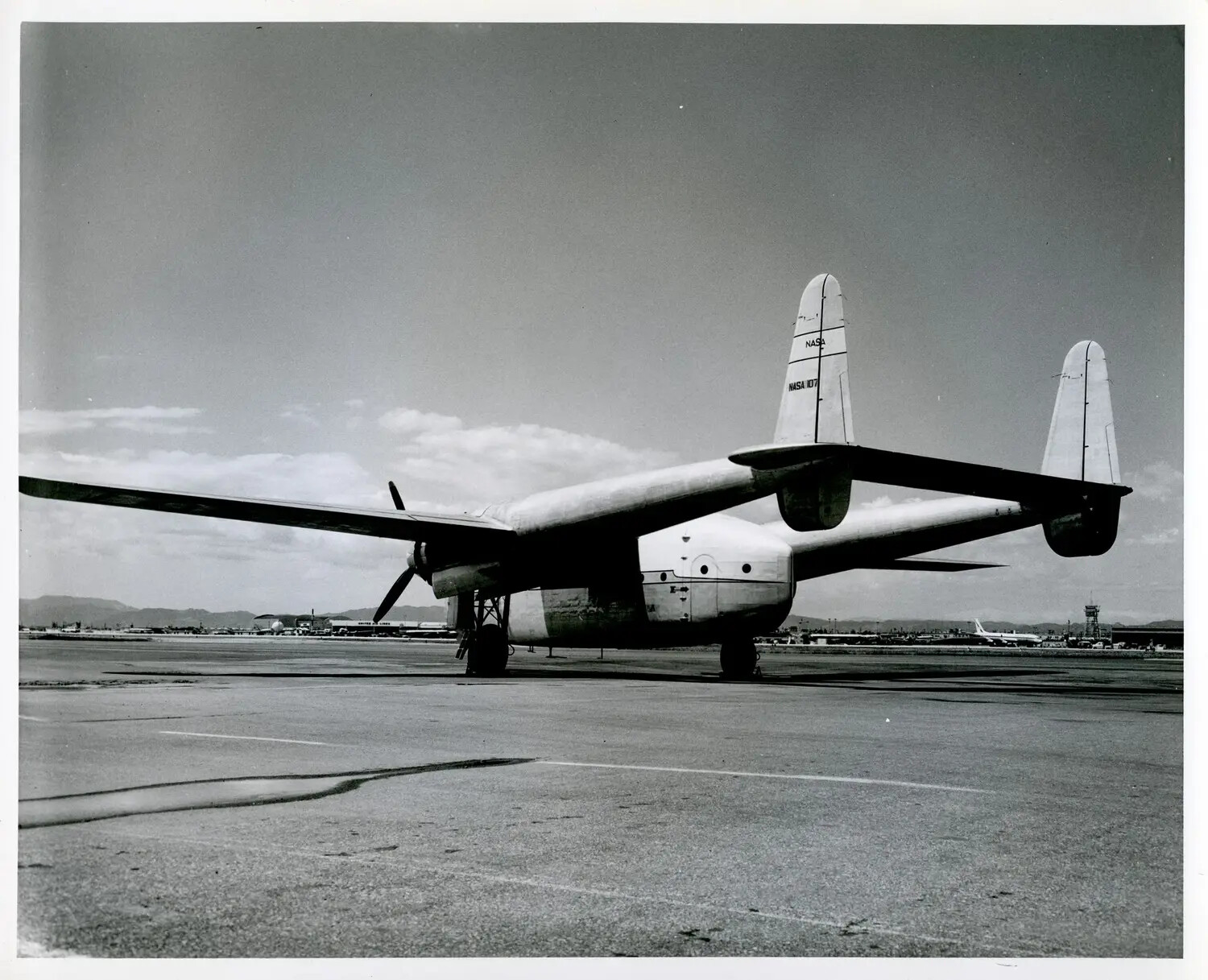 NASA-Marked Twin-Boom Cargo Aircraft (Fairchild C-119-type) on Airport Ramp, "NASA 107"
