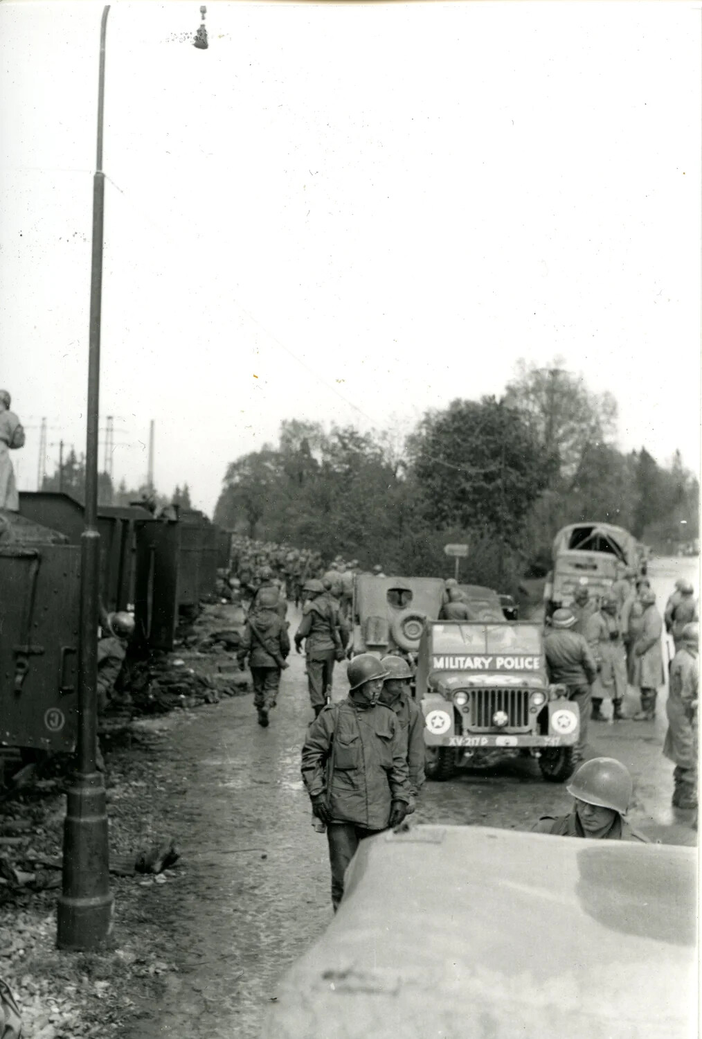 U.S. Army Column and Military Police Jeep Along Rail Line, Germany, World War II