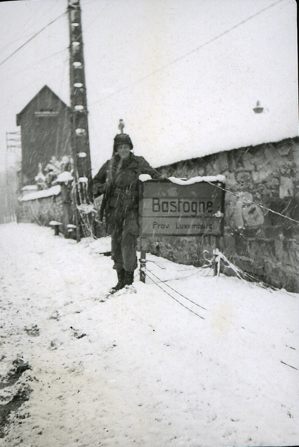 U.S. Soldier at the Bastogne Town Sign in Snow, Battle of the Bulge, Belgium, Winter 1944-1945