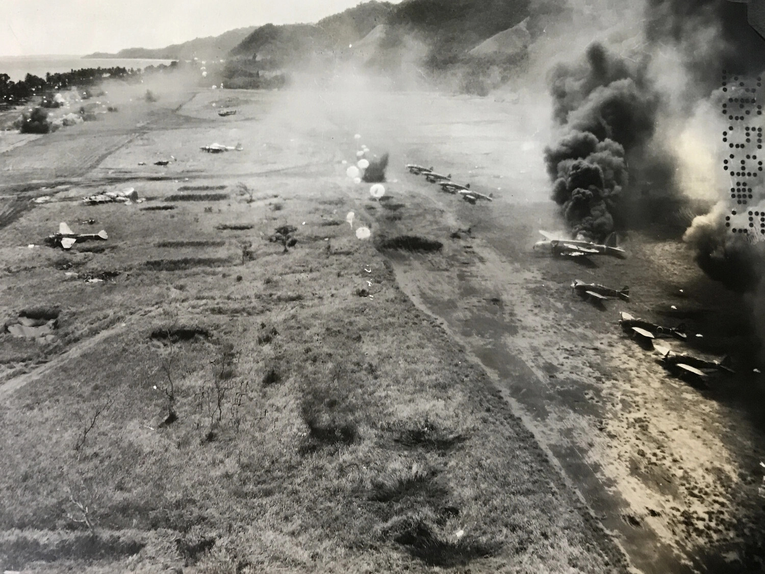 B-25 Parafrag Strike in Progress - Burning Japanese Aircraft, Wewak-Area Airfield, New Guinea