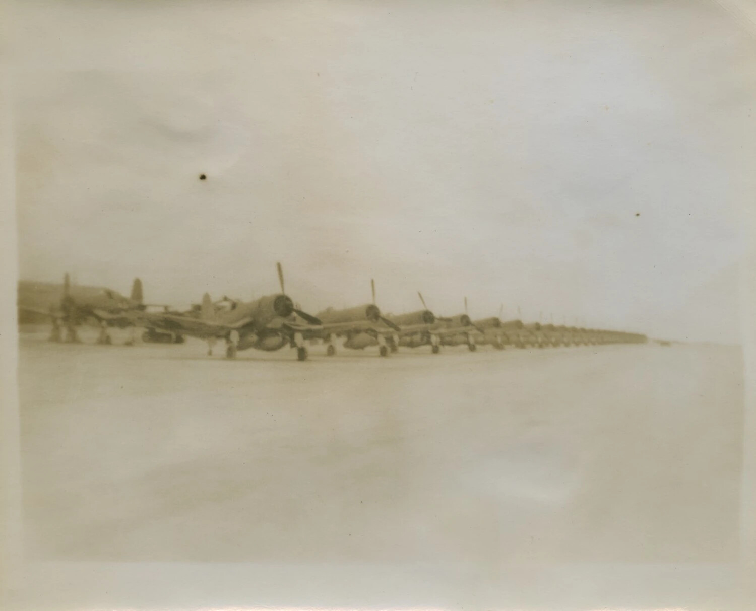 Long Row of Parked Single-Engine Fighter Aircraft on Airfield Ramp