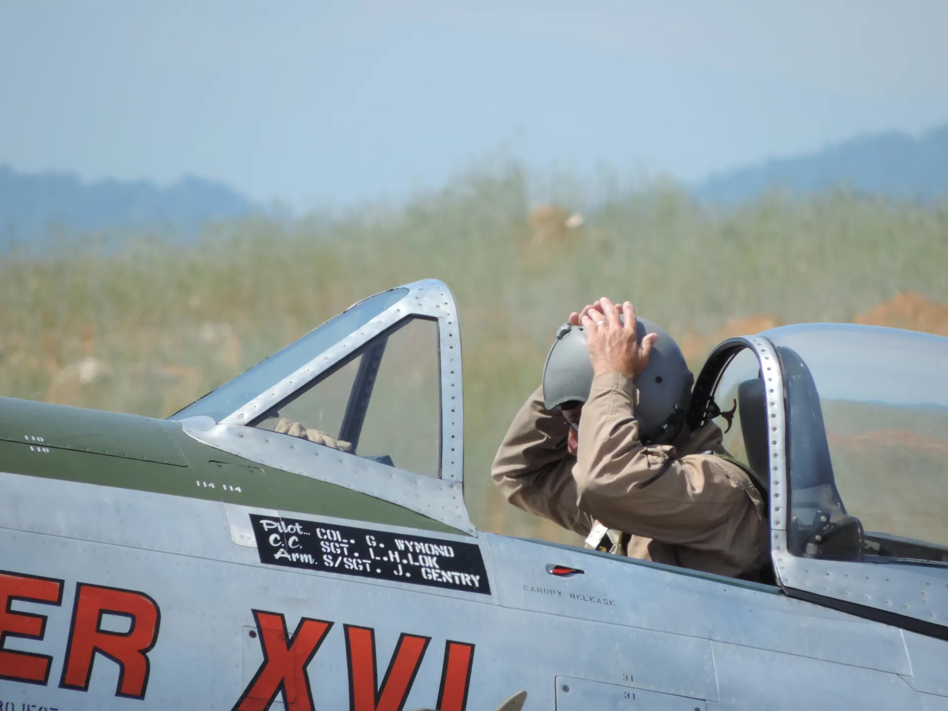 P-47 Thunderbolt "Hun Hunter XVI" - Pilot Adjusting Helmet, Crew Stencil Visible