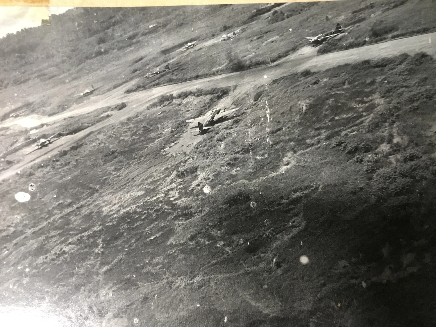 Low-Level Oblique Photograph of Japanese Fighter Aircraft Dispersed on Airfield (Duplicate Print)