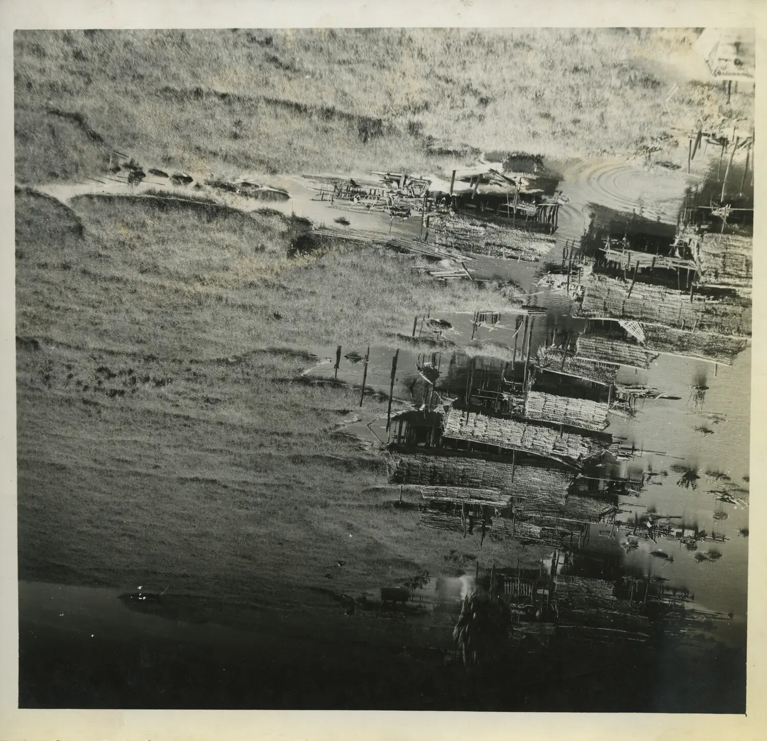 Aerial Reconnaissance Photograph of a Riverside Settlement, Southwest Pacific Theater, World War II