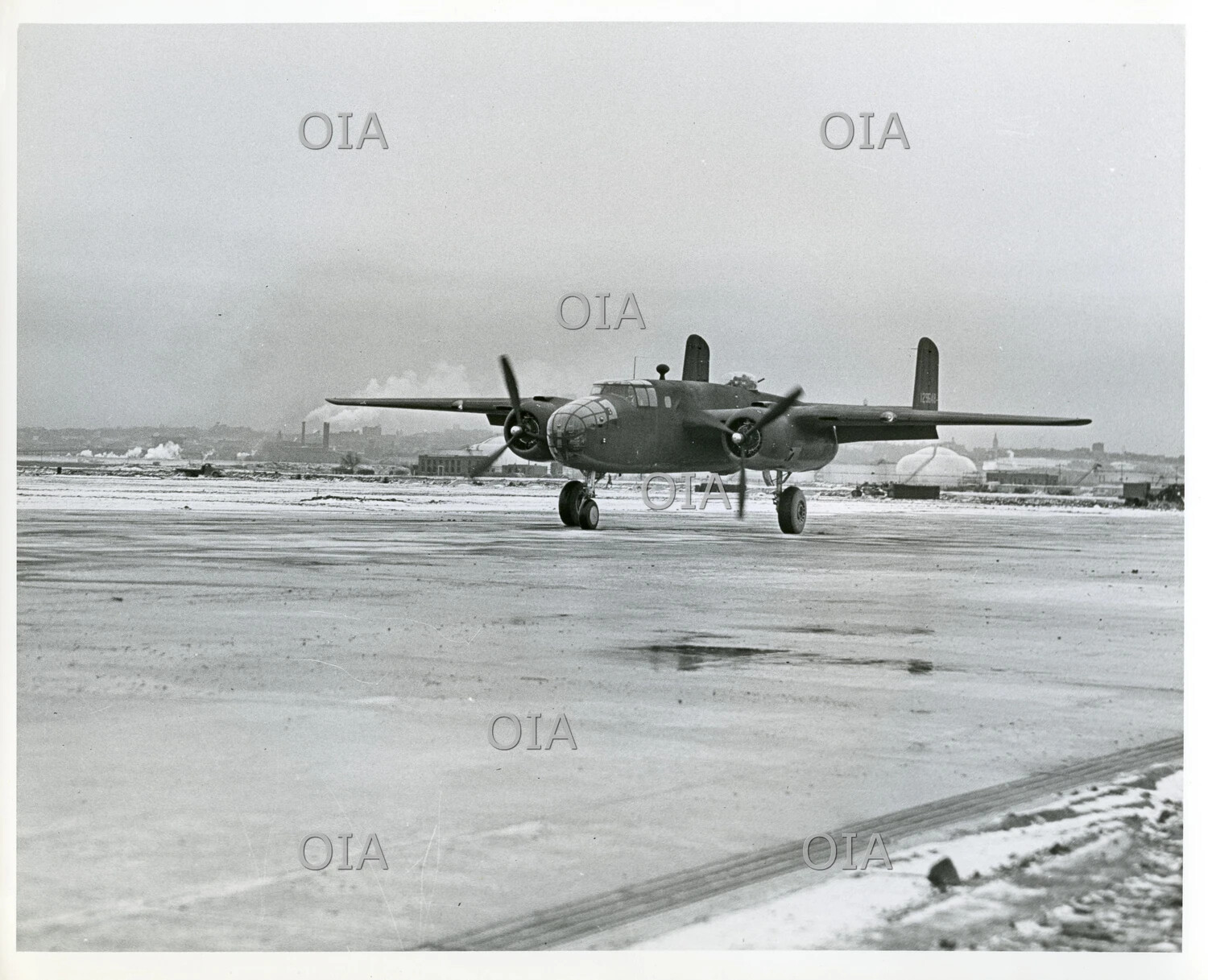 North American B-25 Mitchell Medium Bomber on Snow-Covered Airfield Ramp, World War II Era