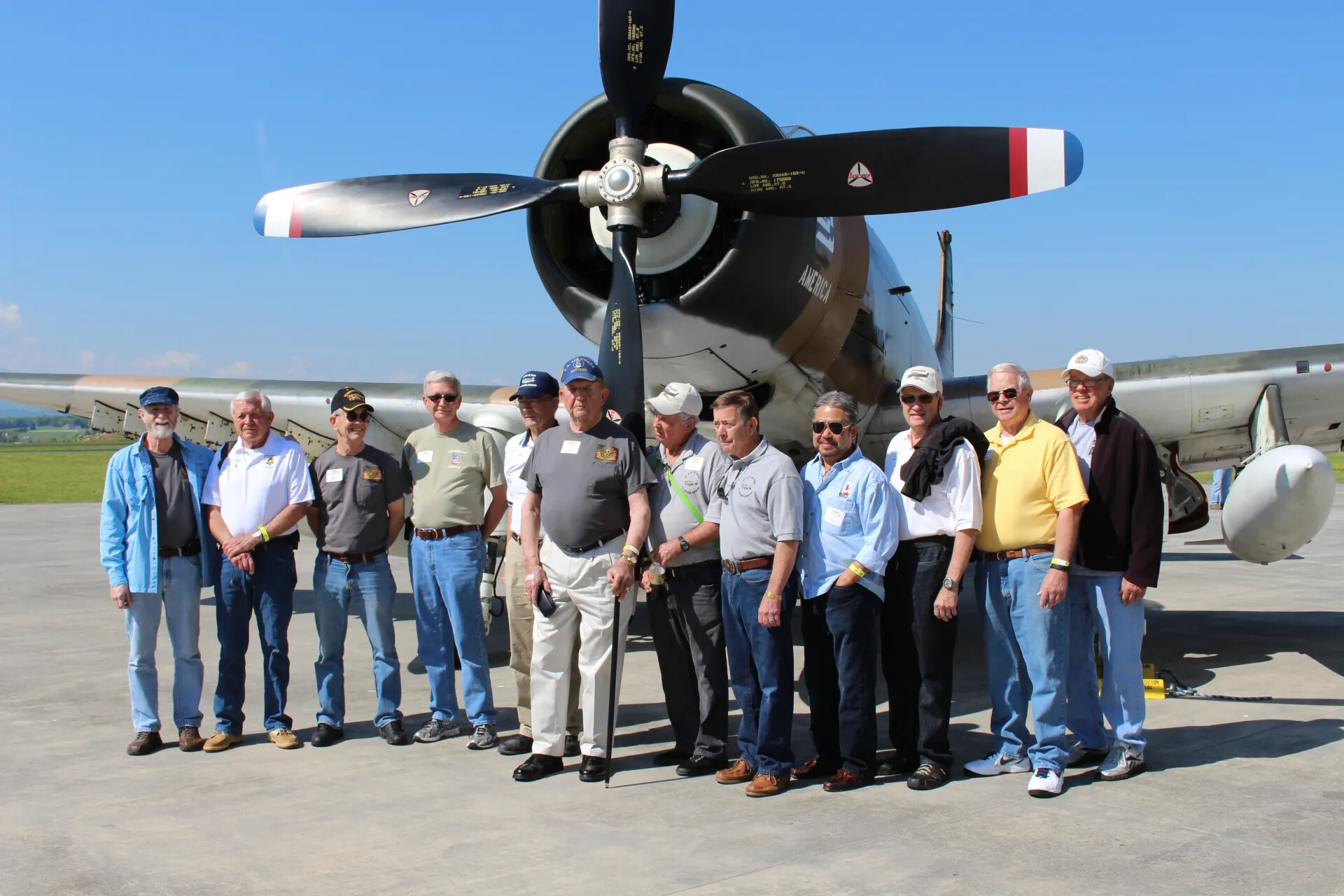 Group Portrait Beneath the Propeller of A-1 Skyraider "Lieutenant America"
