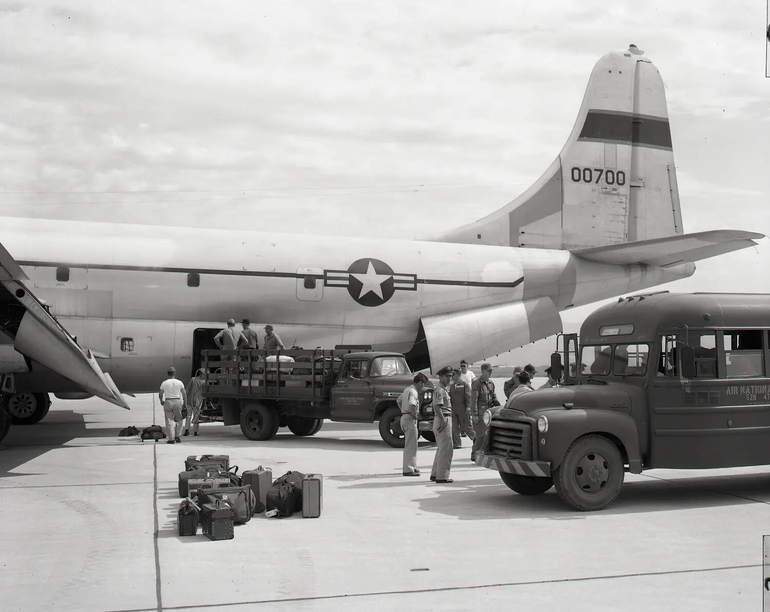 Air National Guard Personnel and Cargo Unloading from C-97/KC-97 Stratofreighter, Tail Number 00700