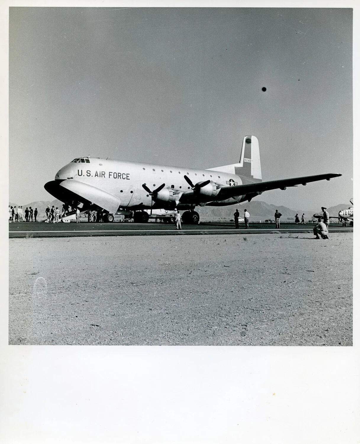 Douglas C-124 Globemaster II on Desert Airfield Ramp with Ground Personnel