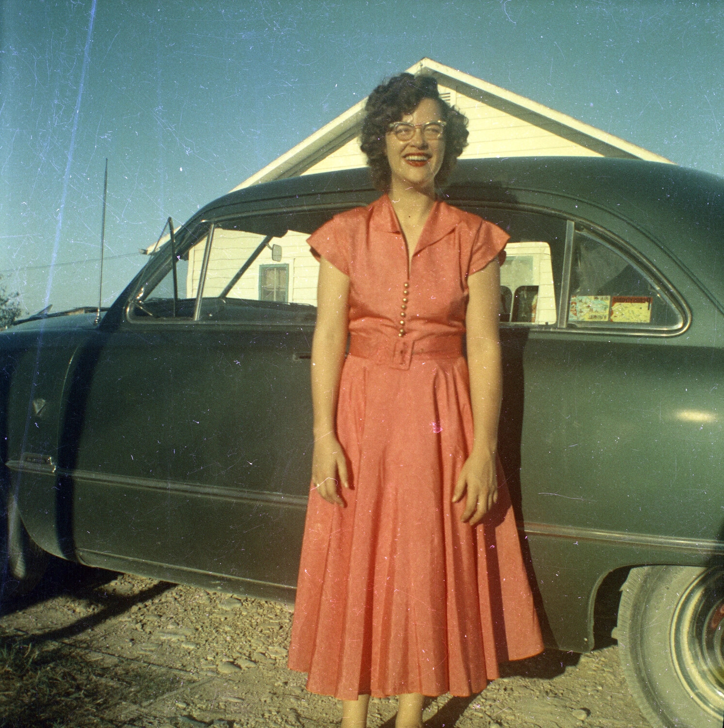 Woman in Coral Dress Beside a Sedan, Mid-1950s