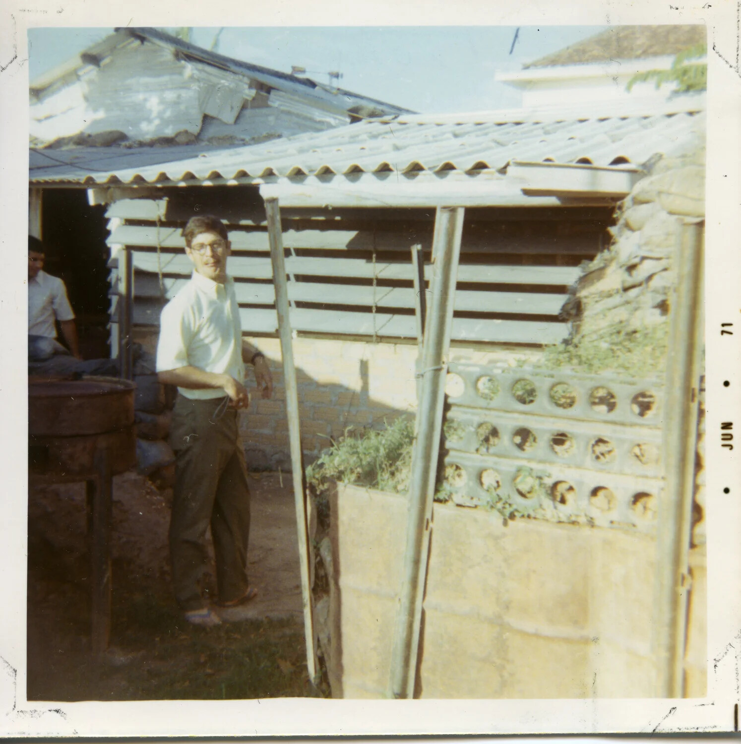 Civilian-Dressed Man in Residential Courtyard with Breeze-Block Wall, Vietnam, June 1971