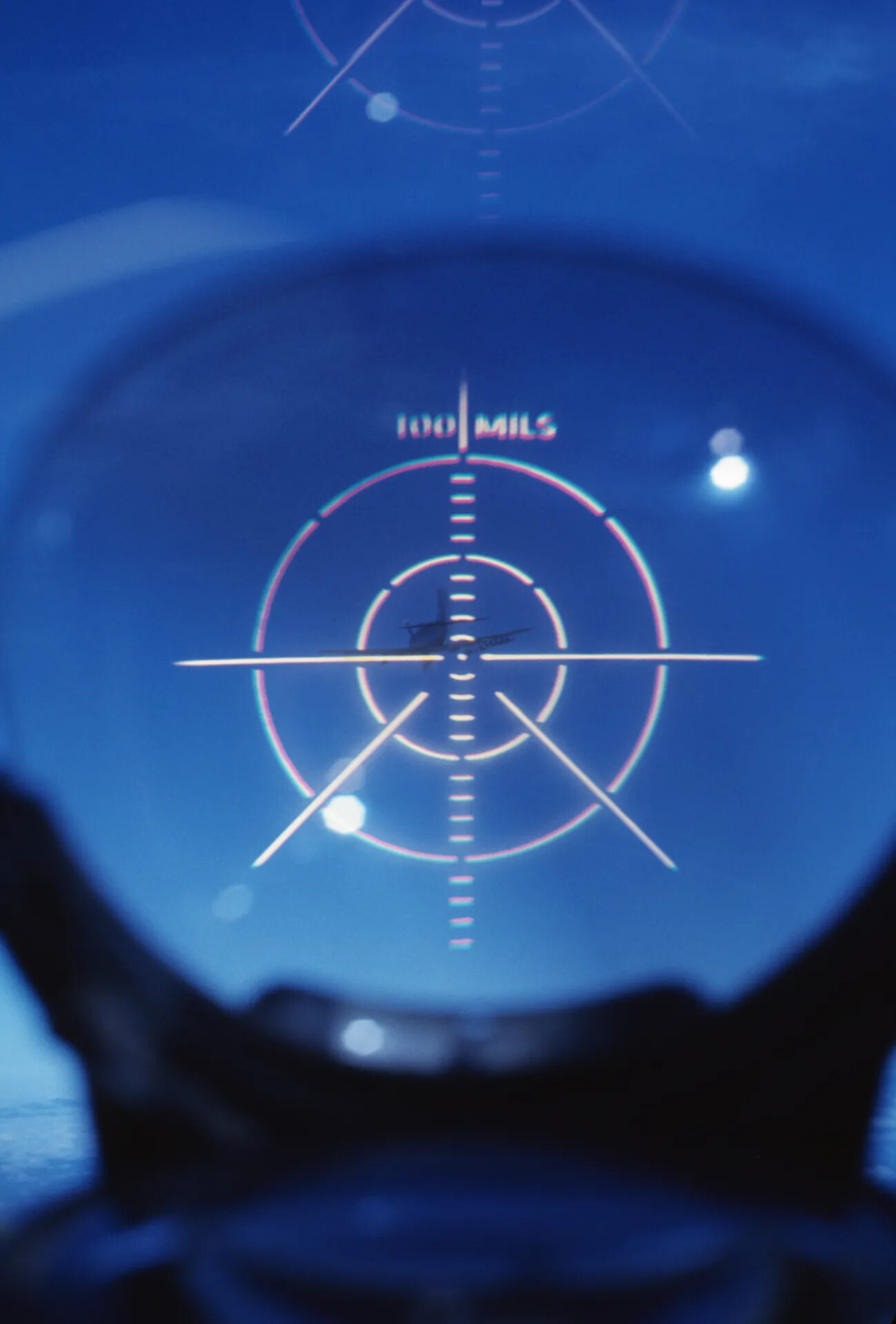 View Through Aircraft Optical Gunsight with Target Aircraft in Reticle, '100 MILS' Ranging Scale
