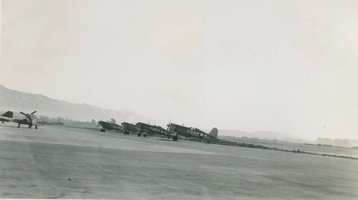 F4U Corsairs Lined Up on Korean Airfield
