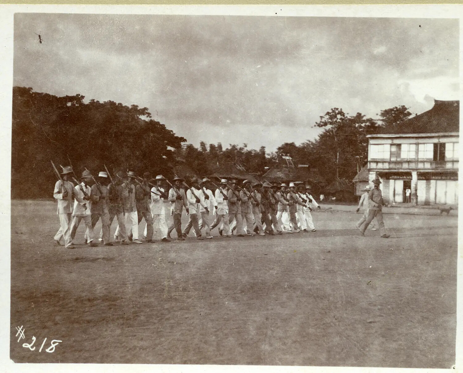 Column of Soldiers Marching Through a Philippine Town Plaza, circa 1890s-1900s
