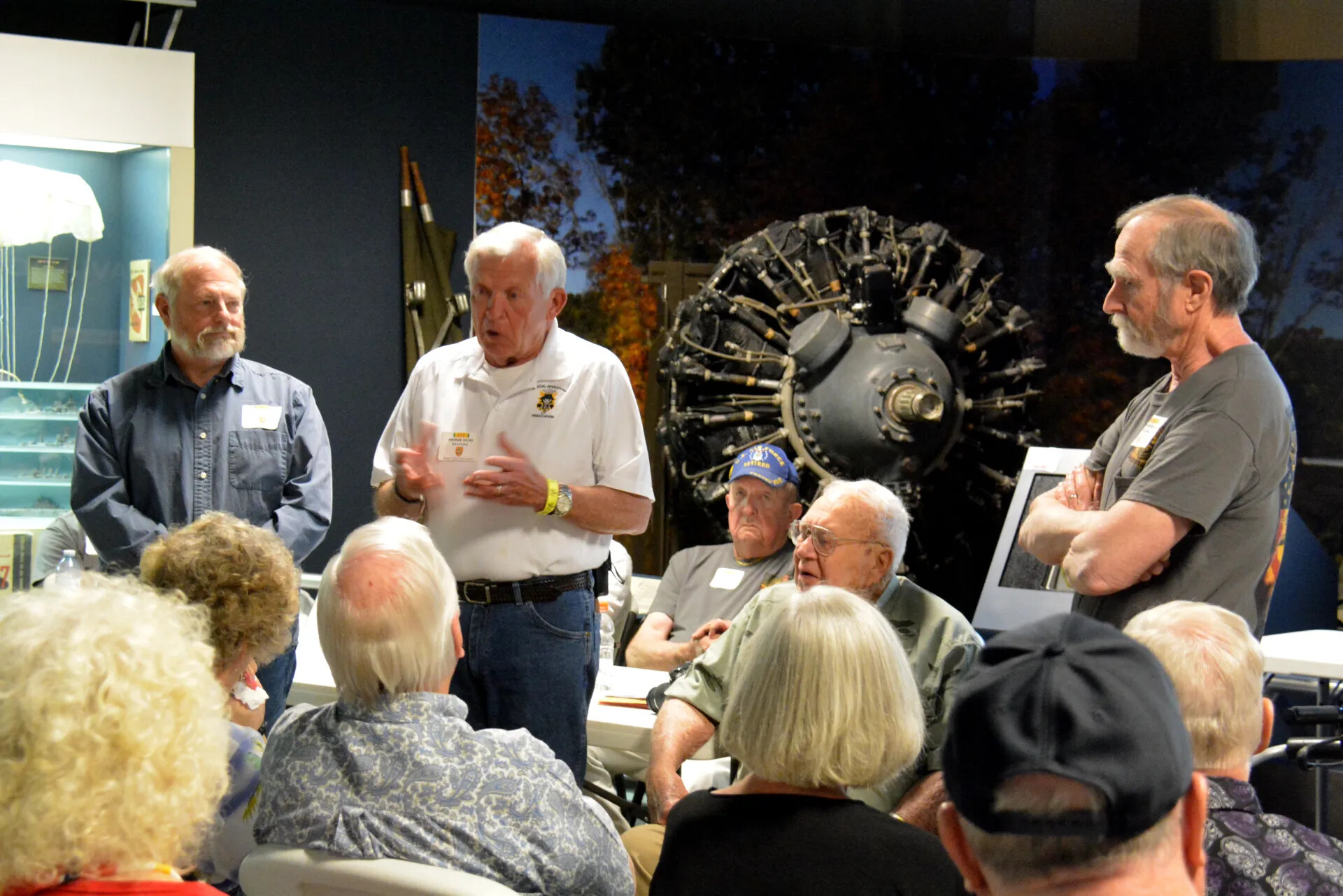 Veterans' Reunion Meeting, Aviation Museum — Special Operations Association Member Addressing Group Beside Radial Engine