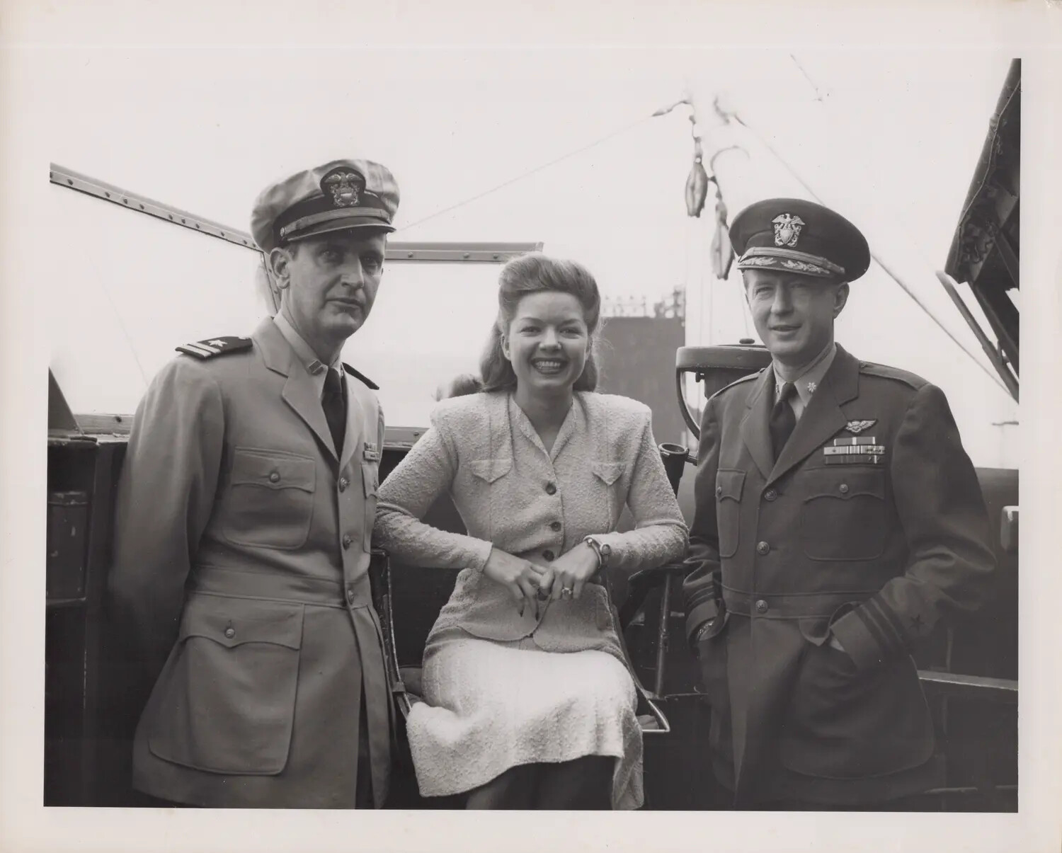 Naval Officers with Civilian Visitor Aboard Ship, WWII Era