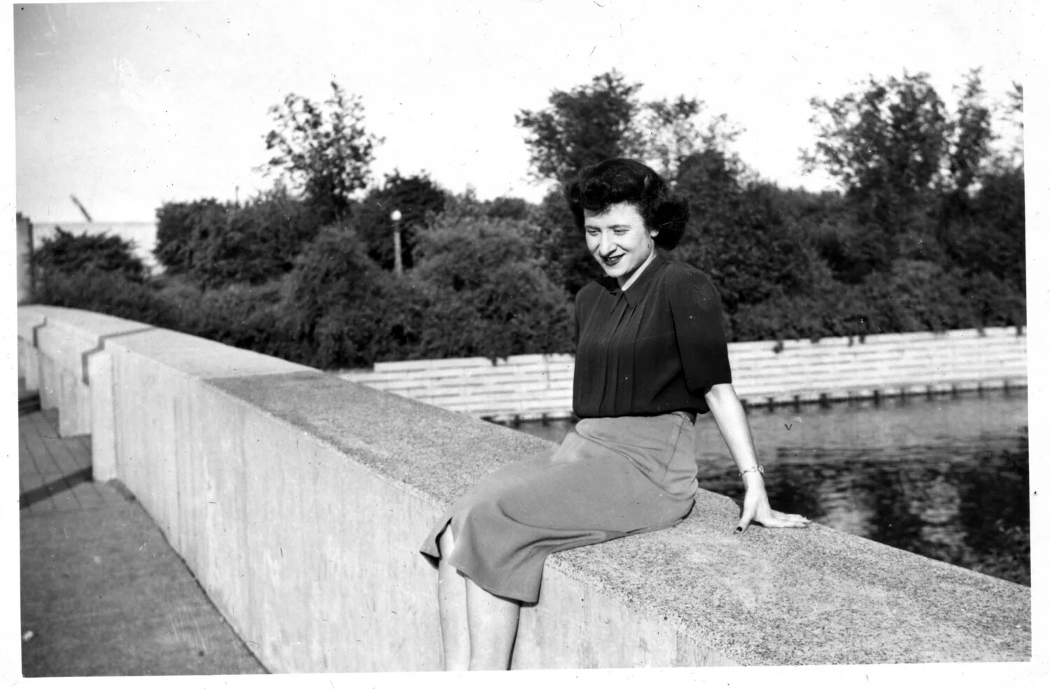 Portrait of a Young Woman Seated on a Wall by the Water, Bancroft Family Collection, Circa Late 1940s