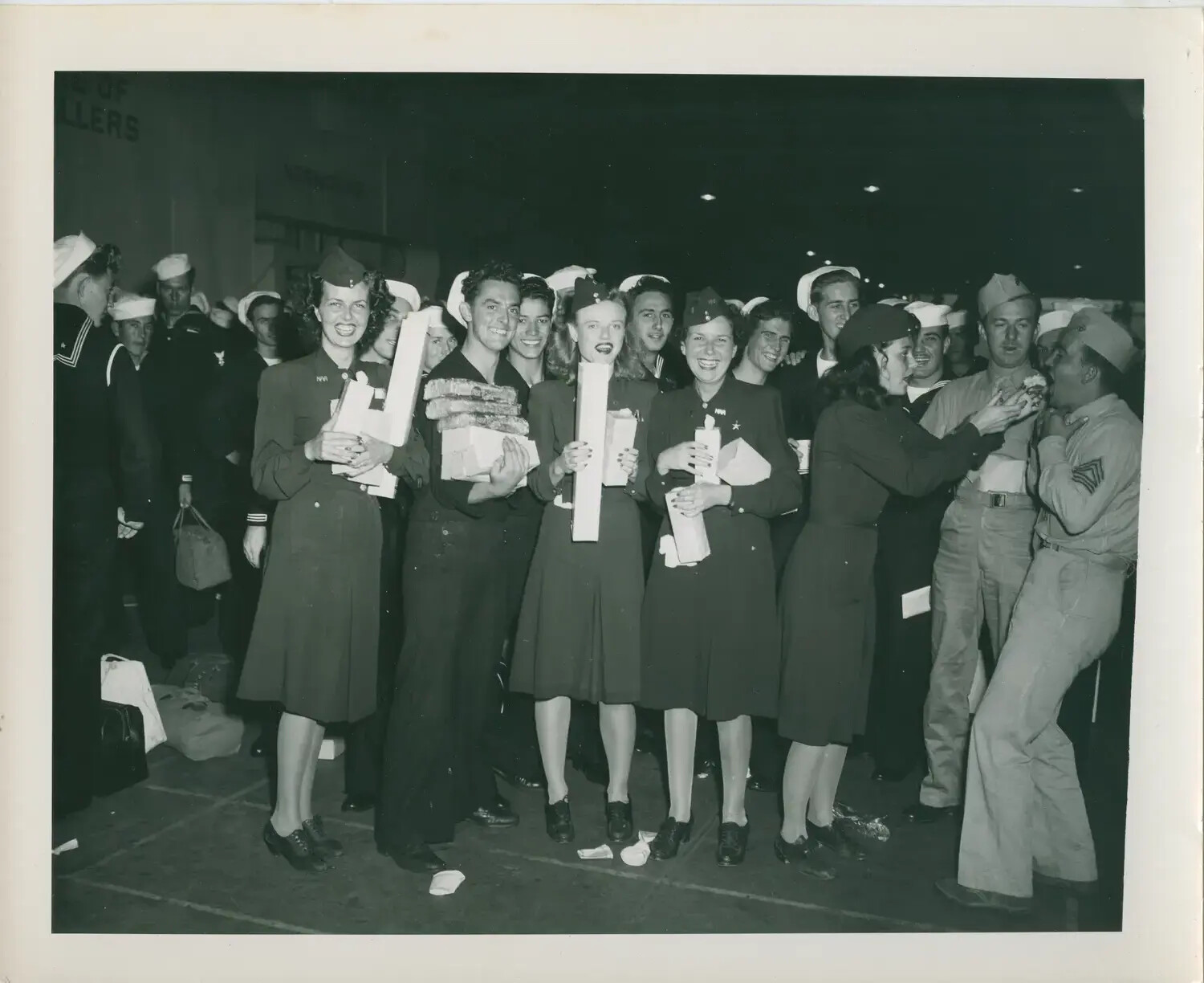 Servicemen Greeted with Care Packages by Navy WAVES at a Reception Hall, WWII