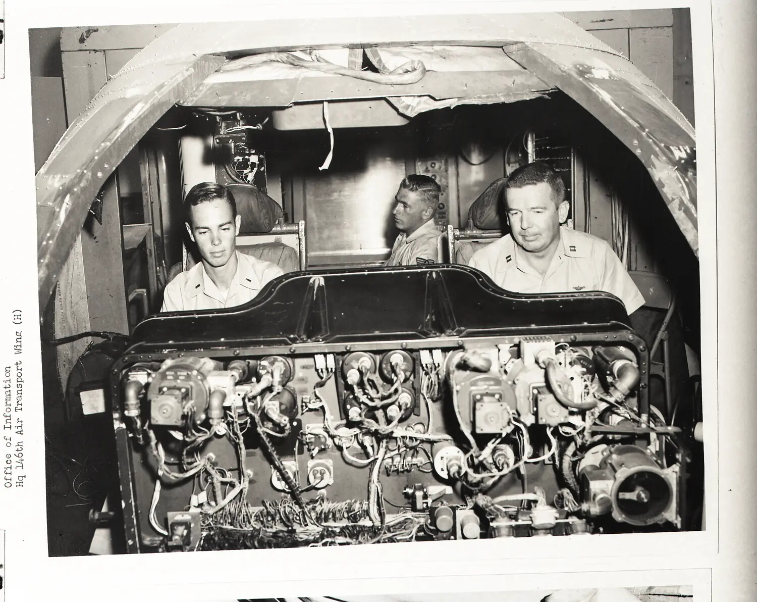 146th Air Transport Wing Airmen Inspecting Aircraft Nose Electronics Bay, September 1960