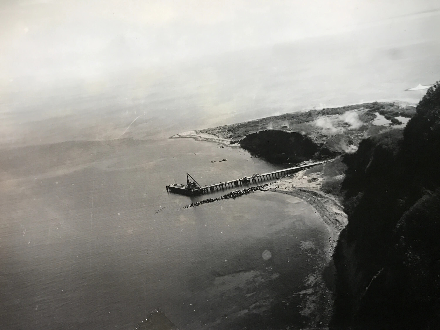 Aerial Photograph of Pier and Floating Crane in Coastal Bay, Pacific Theater (Wide View)