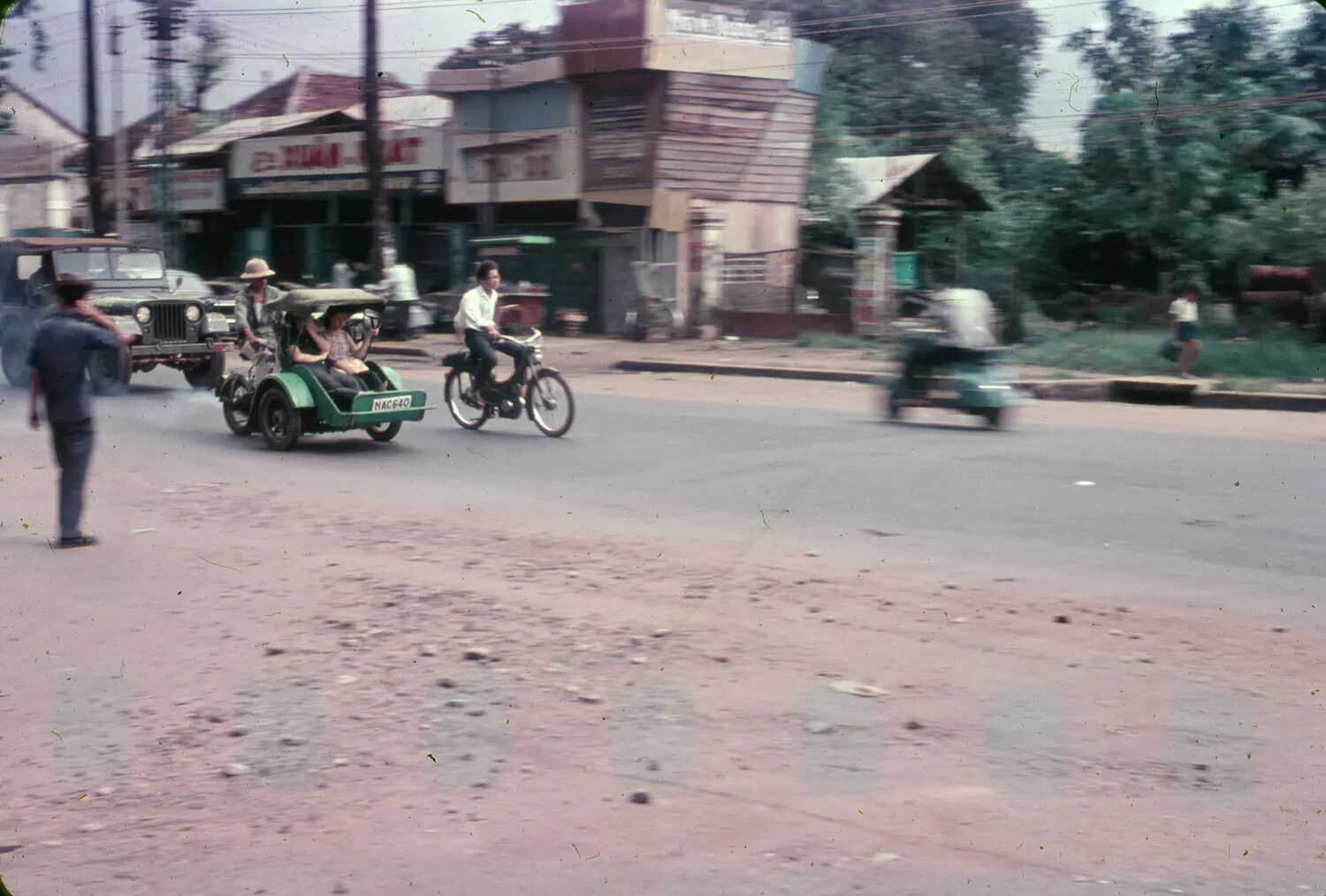 Street Scene with Motorized Taxi and U.S. Military Jeep, South Vietnam, 1965