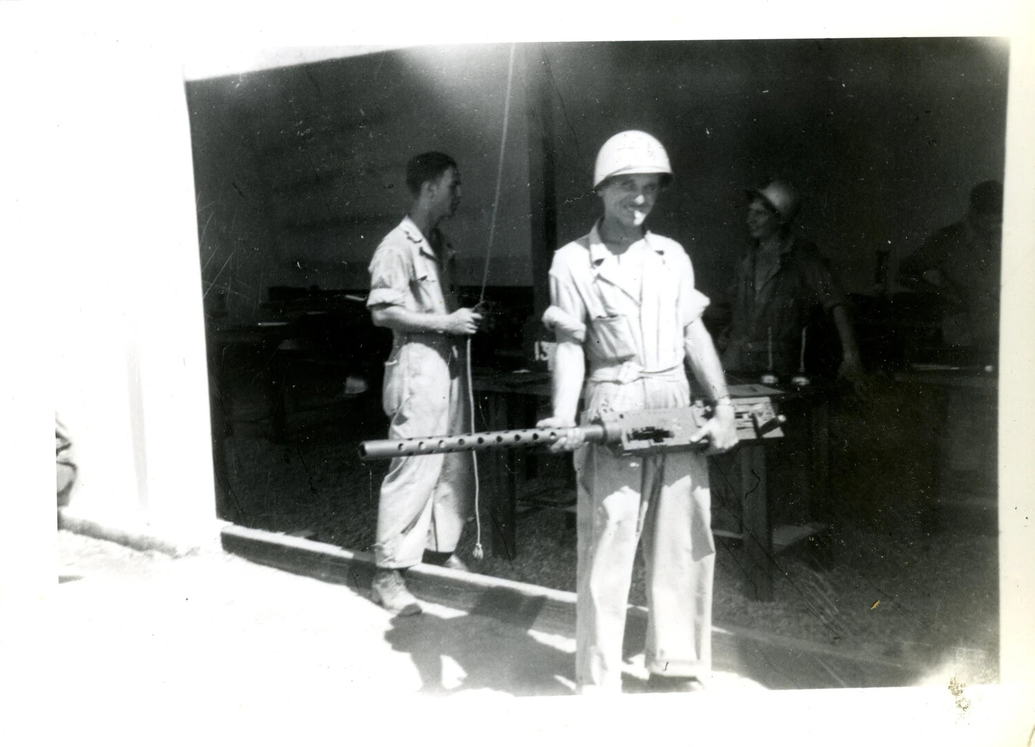Airman Holding a Browning M2 .50 Caliber Machine Gun in Armament Shop