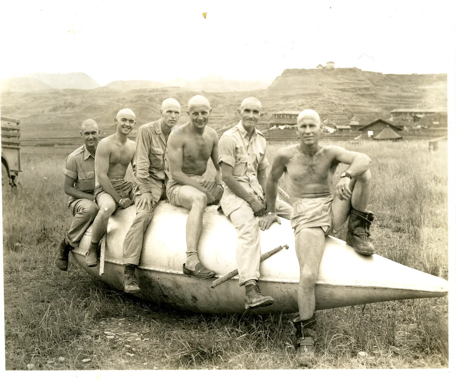 American Servicemen with Shaved Heads Posing on Aircraft Drop Tank, China-Burma-India Theater, WWII